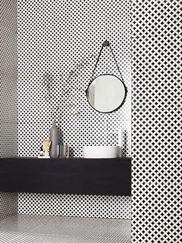 black and white bathroom with mosaic tiles on the walls