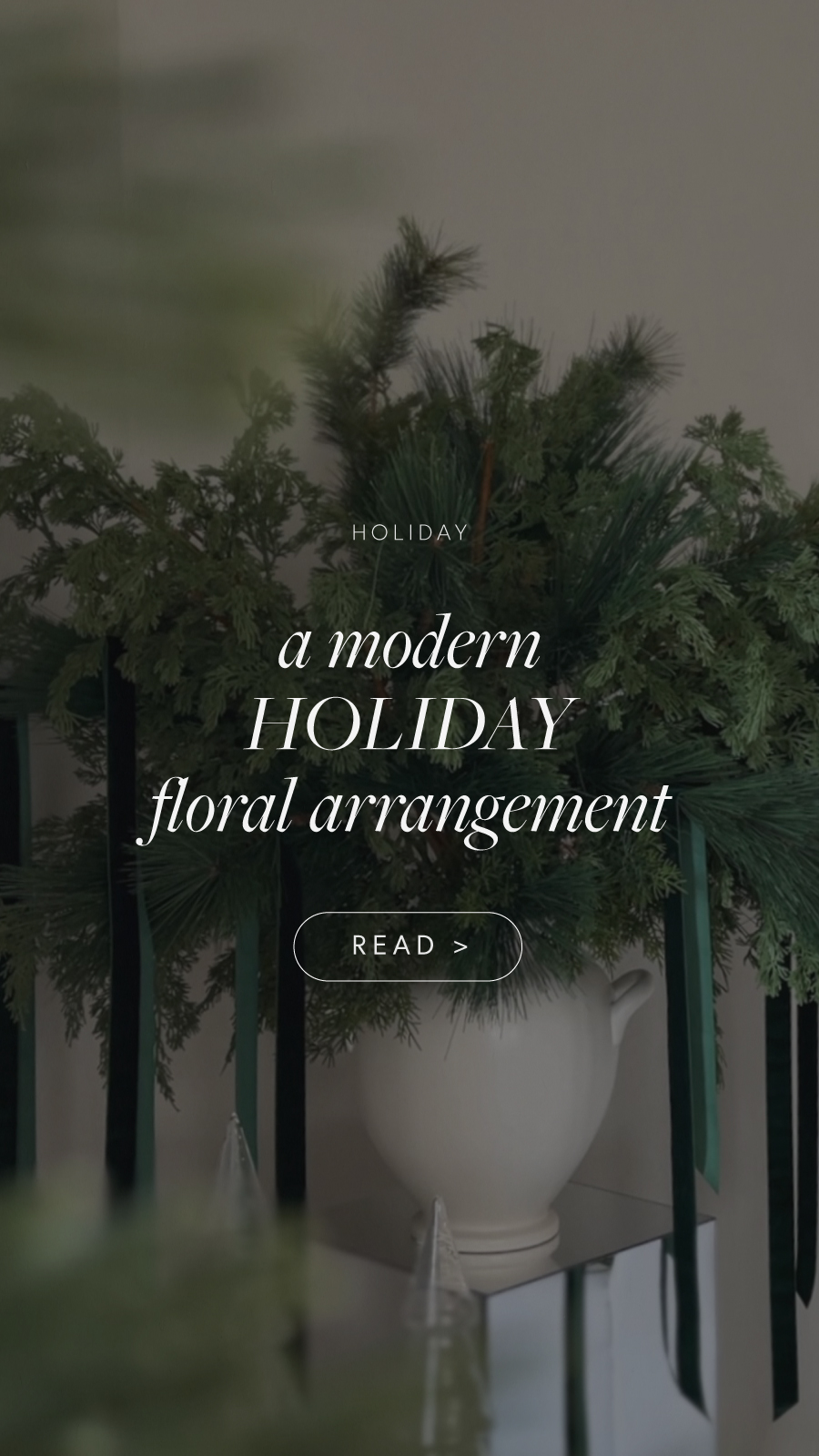 Learn how to design a modern Christmas floral arrangement with cedar and pine faux greenery and branches, velvet ribbon, and mirrored pedestals. Add a touch of elegance and sparkle to your holiday decor!